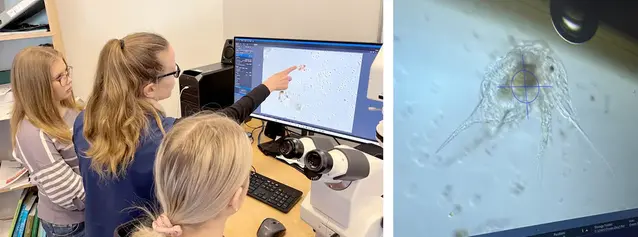 Två tjejer och en marinbiolog tittar på plankton på en datorskärm.