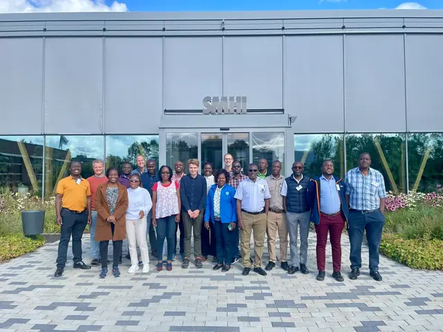 20 personer står framför SMHIs huvudentré och ser glada ut, de har alla deltagit i utbildningsveckan.