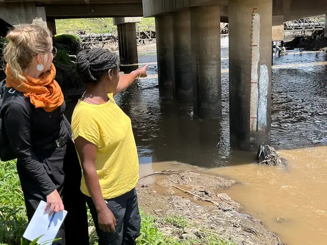 Two persons at a river.