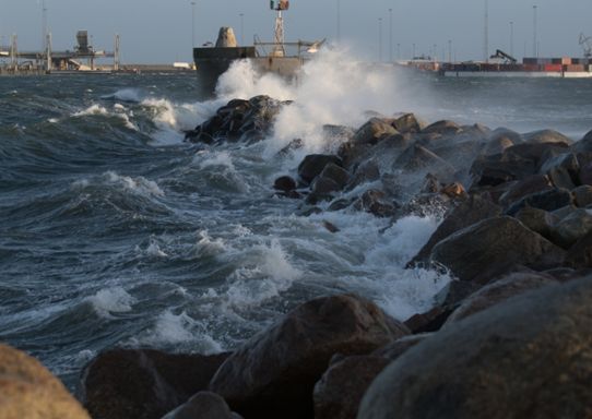 Vågor slår in mot en vågbrytare i Malmö hamn under stormen Gorm